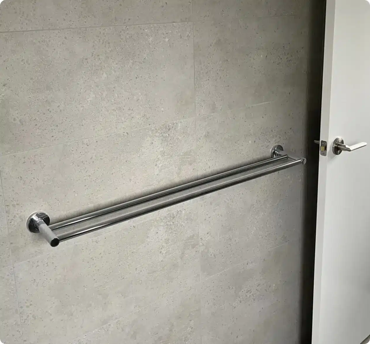 Chrome double towel rail installed in a modern bathroom